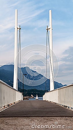 Bridge on the lake with sailing boat Stock Photo