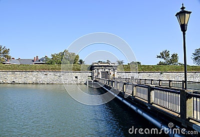 Bridge leading over the moat to Fort Monroe. Street lamp in foreground. Hampton VA, USA. October 4, 2019. Editorial Stock Photo