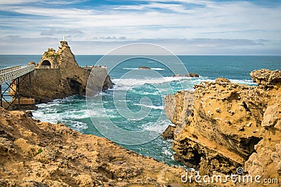 Bridge leading to scenic rocher de la vierge on atlantic coastline in colorful amazing seascape, Biarritz, Basque Country, France Stock Photo