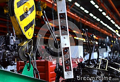 Bridge lifting Crane Hook against the background of the Assembly Line industrial factory. Stock Photo