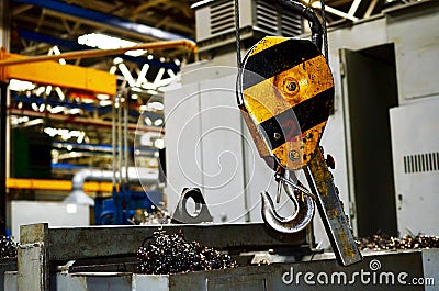 Bridge lifting Crane Hook against the background of the Assembly Line industrial factory. Stock Photo