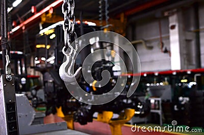 Bridge lifting Crane Hook against the background of the Assembly Line industrial factory. Stock Photo