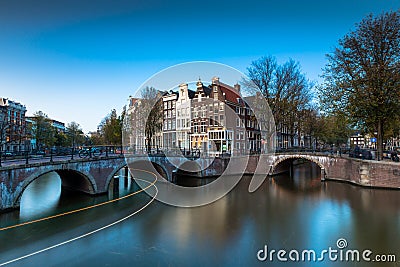 A bridge with lights and boat streaks over the Keizersgracht Canal Stock Photo