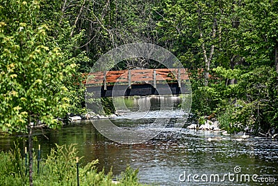 Bridge over Cedar Creek Waterfall in Cedarburg, Wisconsin Stock Photo