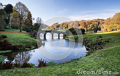 Bridge over main lake in Stourhead Gardens during Autumn. Stock Photo