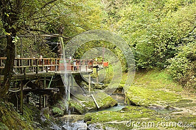 Bridge over a mountain river with an artificial waterfall Editorial Stock Photo