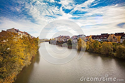 a bridge over a river with a building in the background and a clock tower on top of it, Stock Photo