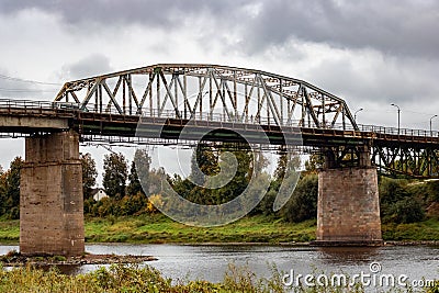 Bridge over the river and gray cloudy sky Stock Photo