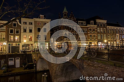 Bridge over Utrecht Oudegracht canal at night with illuminated canal houses Editorial Stock Photo