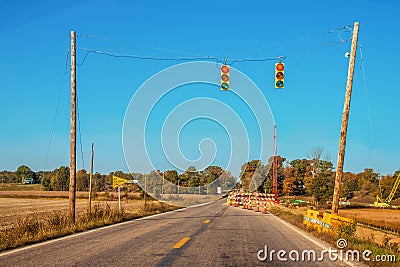 Bridge repair with one lane open and temporary traffic lights in rural Indiana on a late autumn morning with crane and other Stock Photo