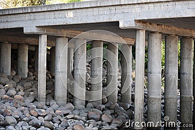 A bridge and river with rocks and shore Stock Photo