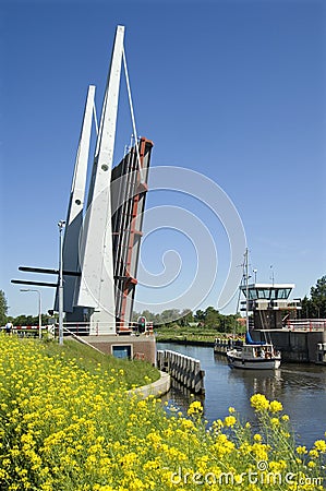 Bridge, shipping boat and wildflowers, Netherlands Editorial Stock Photo