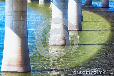 Bridge supports abstract over river Stock Photo