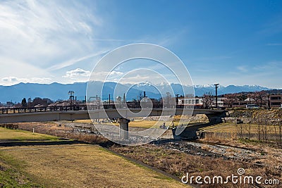 Bridge at Susuki river with central alps, Matsumoto, Nagano, Japan Stock Photo