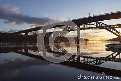 Bridges reflected in water at beautiful, early dawn. Stock Photo