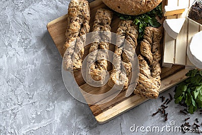 brie cheese with fersh bread and green parsley on the grey backgrounnd Stock Photo