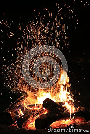 brigh sparkles over burning wood Stock Photo