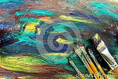 Bright abstract paint drawing background top view texture with brushes Stock Photo