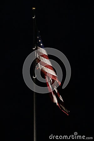 Bright american flag flapping and flying high in night Stock Photo