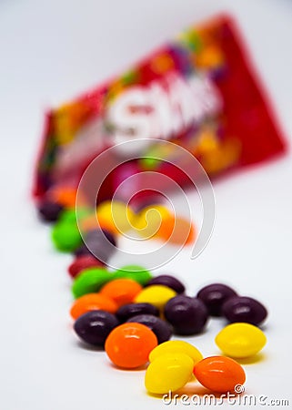 Bright and appetizing candies - skittles. Skittles. Openned pack with skittles in it Editorial Stock Photo