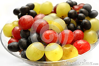 Bright assortment tasty ripe grapes in a glass plate Stock Photo