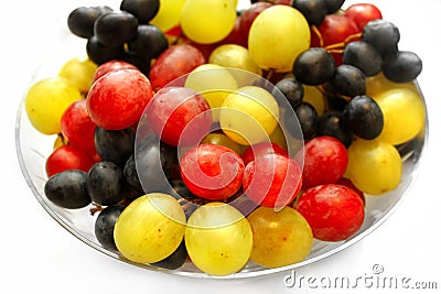 Bright assortment tasty ripe grapes in a glass plate Stock Photo