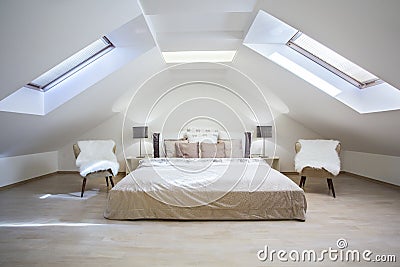 Bright attic bedroom in the apartment Stock Photo