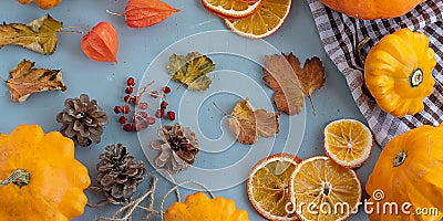 Bright autumn background. Top view of a white and brown checked kitchen towel, orange pumpkin, yellow squash, autumn leaves, Stock Photo