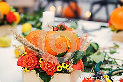 The bright autumn arrangement of flowers and berries in the pumpkin Stock Photo