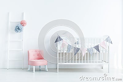 Bright baby room interior with a crib decorated with triangles o Stock Photo
