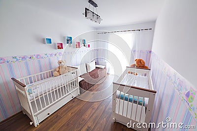 Bright baby room with white cradles Stock Photo