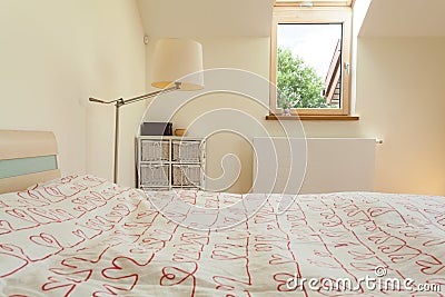 Bright bedroom with small window Stock Photo