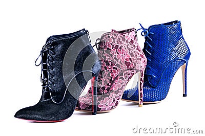 Bright blue, burgundy lace and black fur ankle boots. Footwear of three different colors and materials Editorial Stock Photo