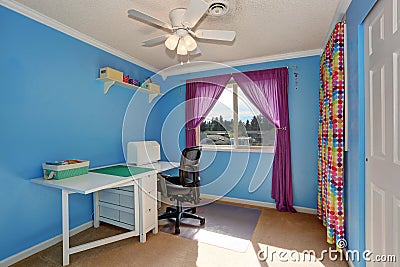 Bright blue sewing room interior with colorful curtains. Stock Photo