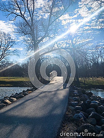 Bright Sunbeam over Path and Bridge Stock Photo