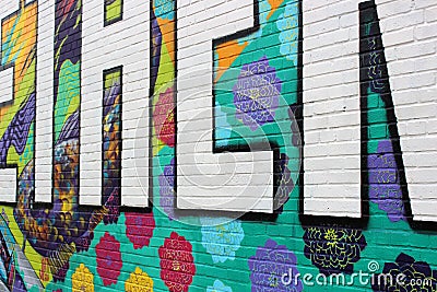 Bright and colorful background of graffiti with flowers and message, downtown Austin, Texas, 2019 Editorial Stock Photo