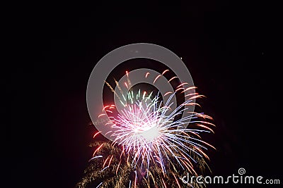 Bright burst of colors explode in the night on 4th if July fireworks celebrating our independence day Stock Photo