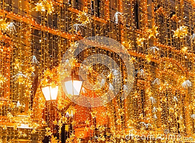 Bright Christmas Street Illumination on the facade of the buildings. The City is Decorated for the Christmastide Holiday Stock Photo