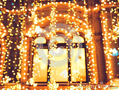 Bright Christmas Street Illumination on the facade of the buildings with windows. The City is Decorated for the Christmastide Holi Stock Photo