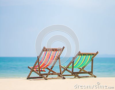 Bright color wooden beach chairs on island tropical beach Stock Photo