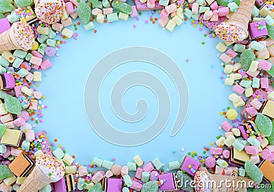 Bright colorful candy on pale blue wood table. Stock Photo