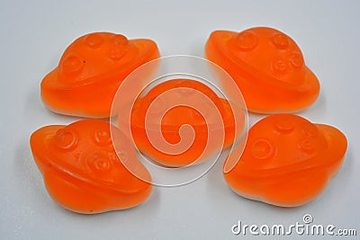 Bright and colorful, colored jelly children's sweets, candies in the form of orange planets, an asteroid, jupiter Editorial Stock Photo