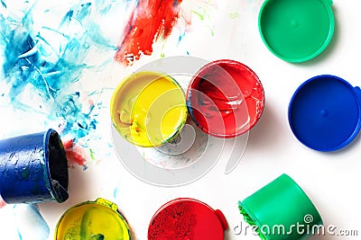 Bright colorful finger paint pots with paint prints Stock Photo