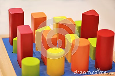 Bright colorful wooden children toy sorter on a shelf in the shop. Stock Photo