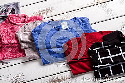 Bright and dark-colored sweaters. Stock Photo