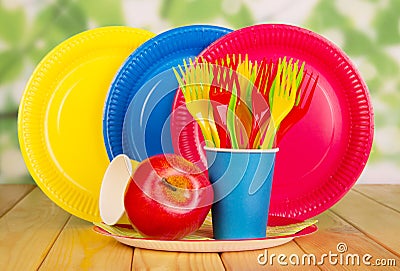 Bright, disposable tableware on abstract green Stock Photo