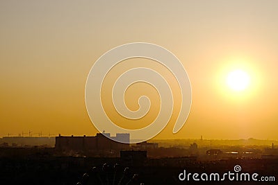 Bright evening sun over an abstract silhouette city. Stock Photo