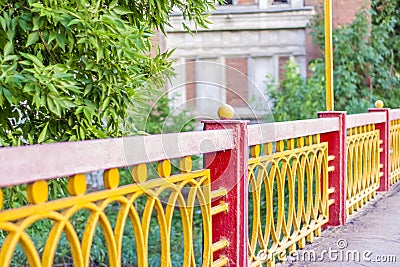 Bright fences on the background of the destroyed factory building. Stock Photo