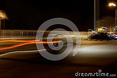 Trail brake lights of a car at night in the city. Stock Photo