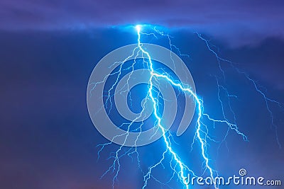 Bright flash of lightning strike during a night thunderstorm in the sky. Stock Photo